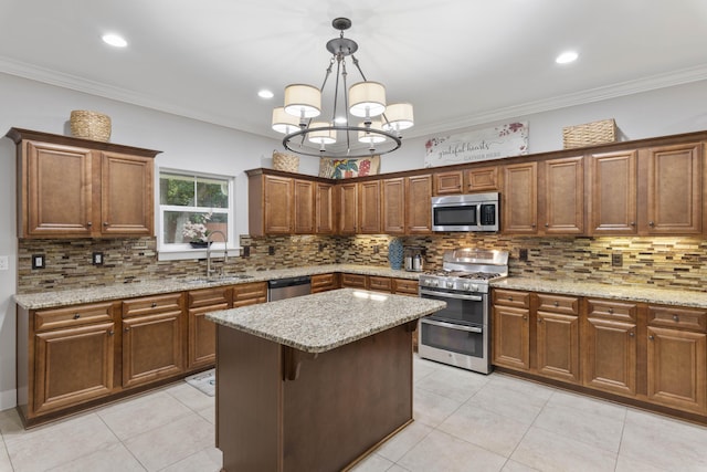 kitchen with pendant lighting, sink, ornamental molding, a center island, and stainless steel appliances