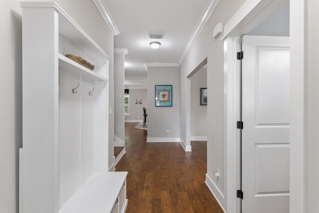 mudroom with ornamental molding and dark hardwood / wood-style floors