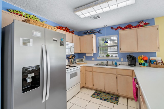 kitchen with sink, white appliances, a textured ceiling, and light brown cabinets