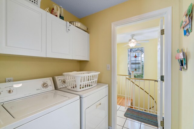 washroom featuring light tile patterned flooring, independent washer and dryer, cabinets, and ceiling fan