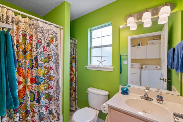 bathroom with vanity, washing machine and dryer, a textured ceiling, and toilet