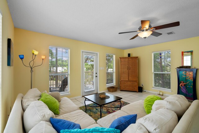 tiled living room featuring ceiling fan