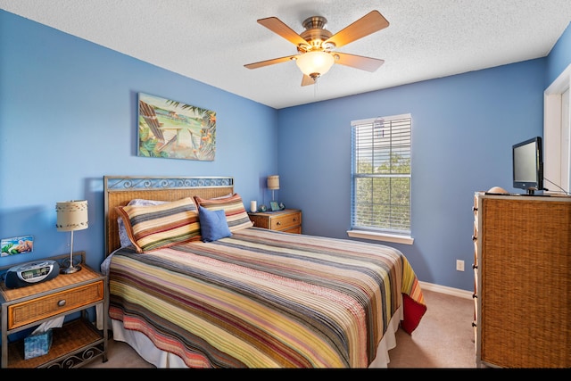 carpeted bedroom with a textured ceiling and ceiling fan