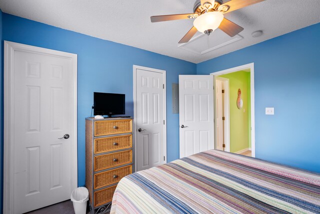 bedroom with a textured ceiling and ceiling fan