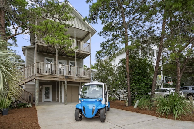 view of front facade with a carport and a balcony