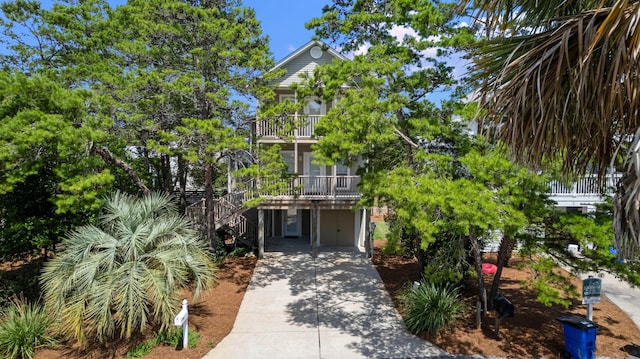 view of front of home featuring a balcony and a garage