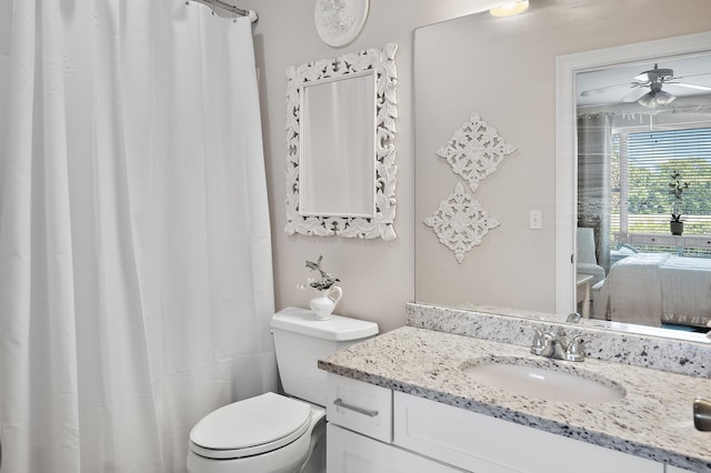 bathroom featuring vanity, ceiling fan, and toilet