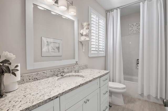 full bathroom with shower / bath combo, toilet, and vanity