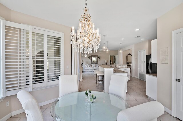 dining room featuring light tile patterned flooring, sink, and an inviting chandelier