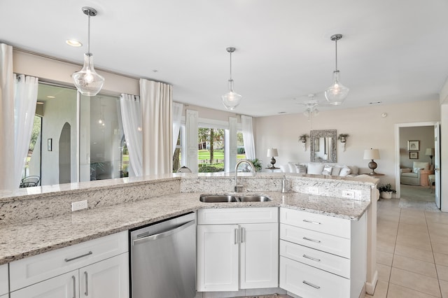 kitchen featuring hanging light fixtures, white cabinetry, dishwasher, and light tile patterned flooring