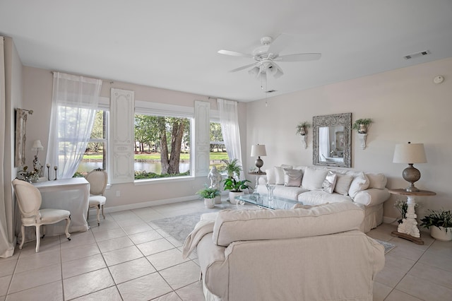 living room featuring light tile patterned floors and ceiling fan