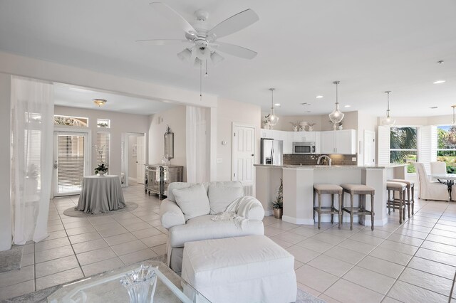 living room with light tile patterned floors and ceiling fan