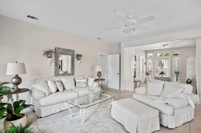 living room with light tile patterned flooring and ceiling fan