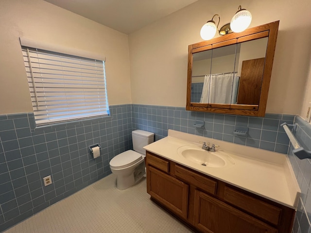 bathroom featuring vanity, tile walls, tile patterned floors, and toilet