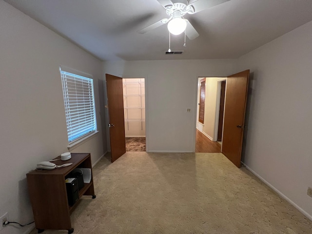 unfurnished bedroom with ceiling fan and carpet