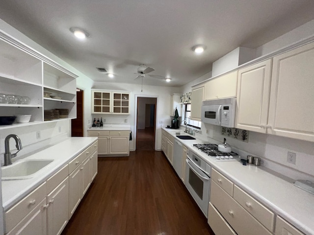 kitchen with white cabinetry, sink, gas stovetop, and oven