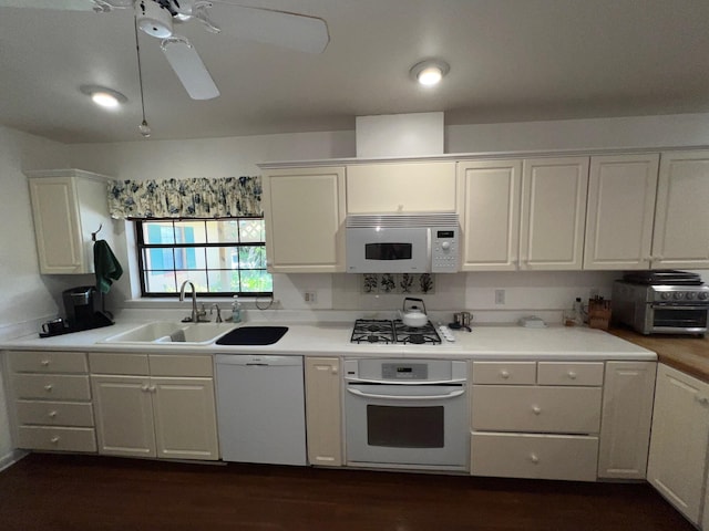 kitchen featuring ceiling fan, sink, white cabinets, and white appliances