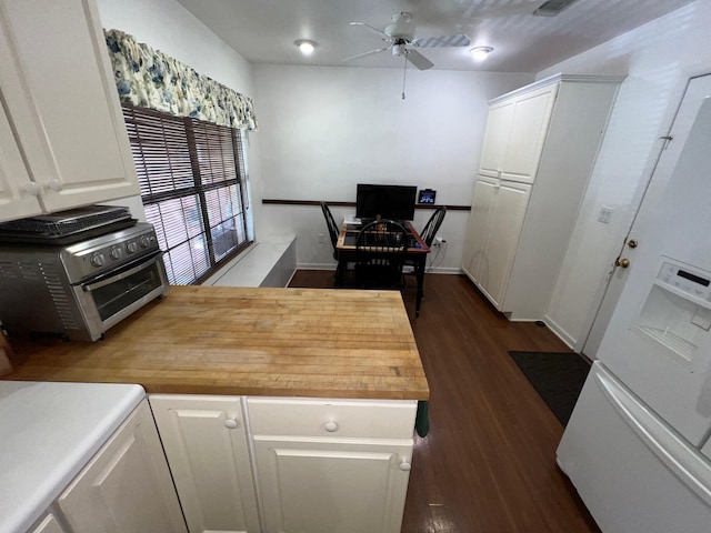 kitchen with white cabinetry, ceiling fan, dark wood-type flooring, and butcher block counters