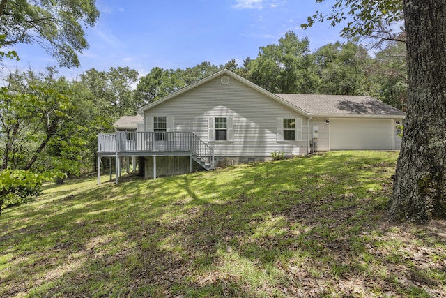 exterior space featuring a deck, a garage, and a lawn