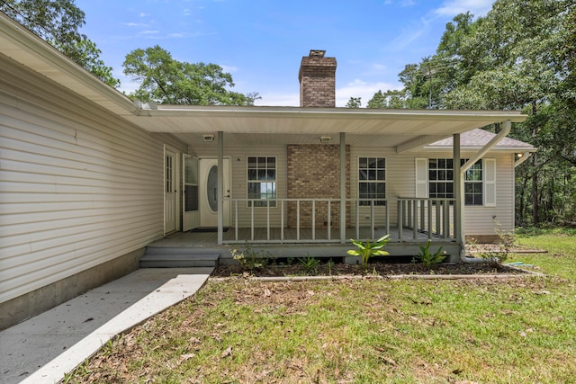 exterior space with a porch and a lawn