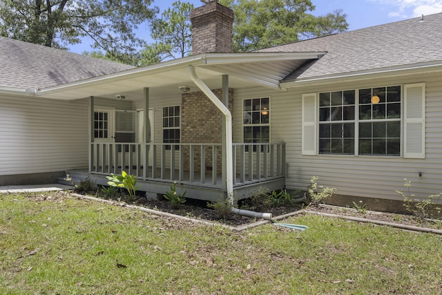 entrance to property featuring a yard