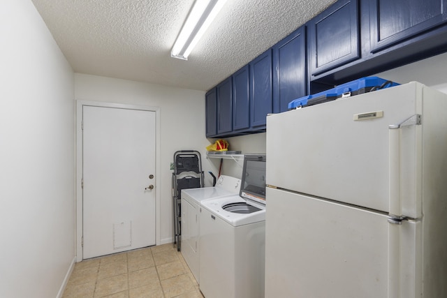 washroom featuring washing machine and dryer, a textured ceiling, cabinets, and light tile patterned floors