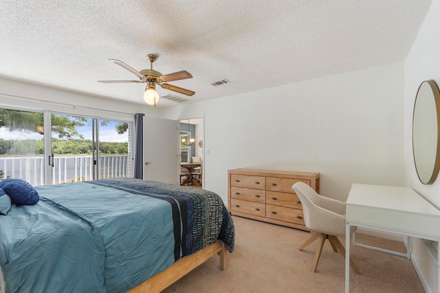 carpeted bedroom featuring a textured ceiling, access to outside, and ceiling fan