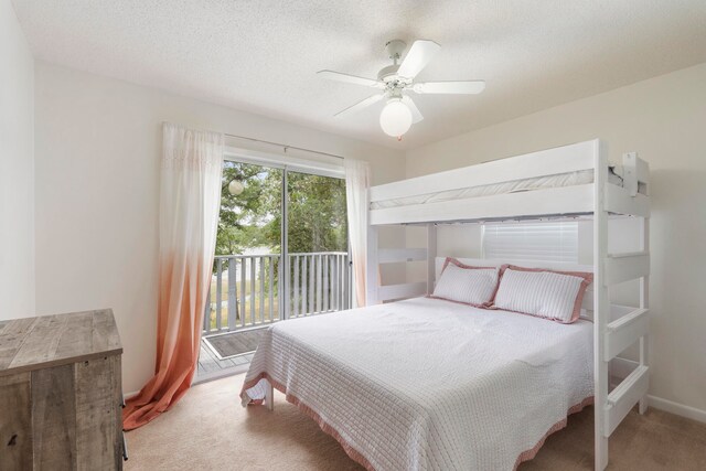 carpeted bedroom with a textured ceiling, ceiling fan, and access to exterior