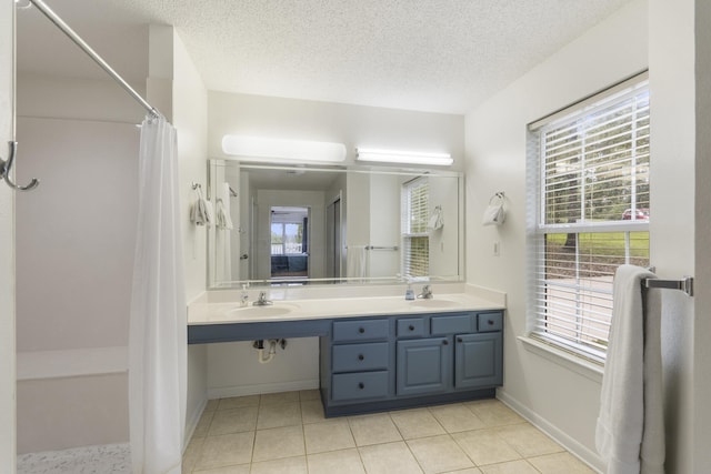 bathroom with tile patterned floors, double sink vanity, and plenty of natural light