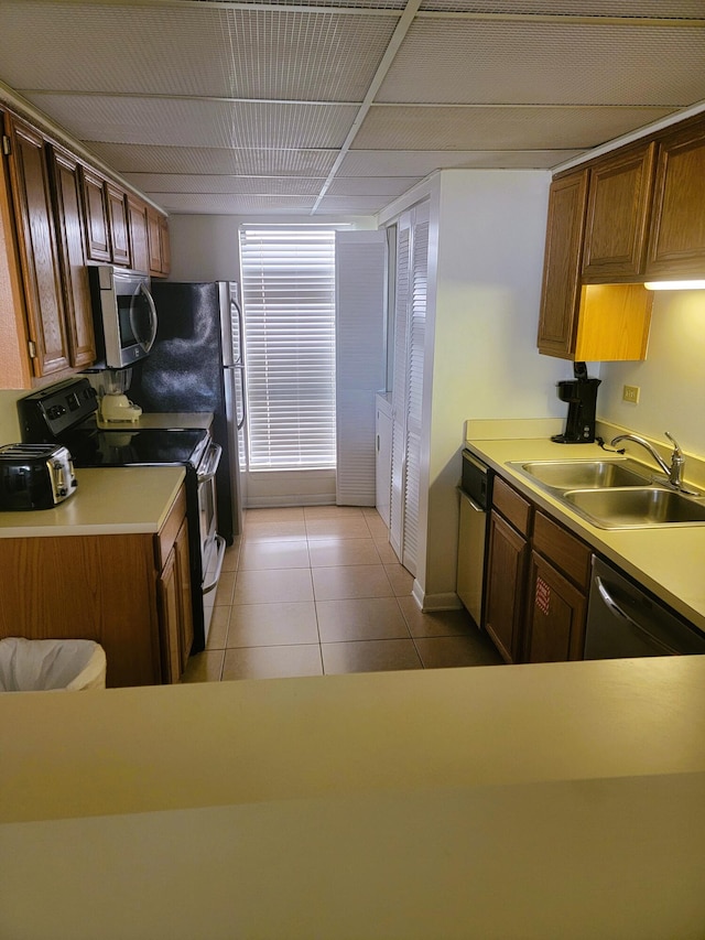 kitchen featuring sink, appliances with stainless steel finishes, and light tile patterned floors