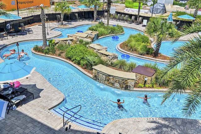 view of pool featuring pool water feature and a patio