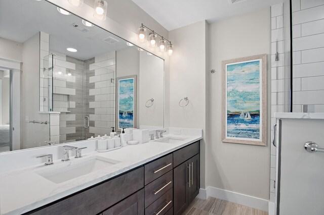 bathroom with vanity and a shower with shower door