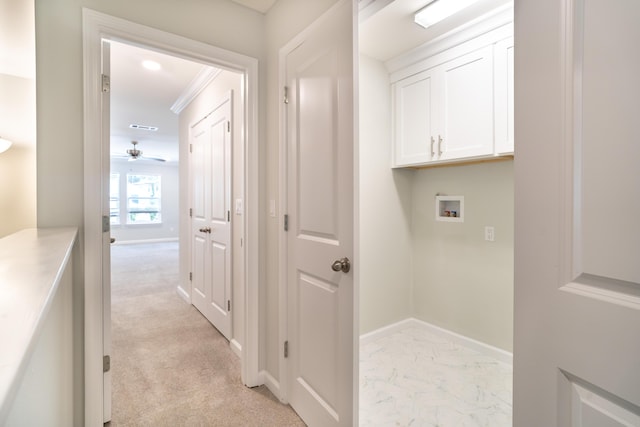 laundry room featuring washer hookup, light colored carpet, cabinets, and ceiling fan