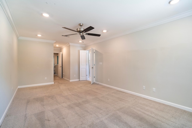 carpeted spare room with crown molding and ceiling fan