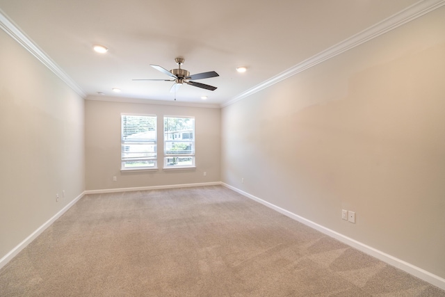 spare room with light carpet, ornamental molding, and ceiling fan