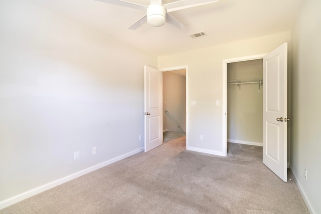 unfurnished bedroom featuring a closet, ceiling fan, and light colored carpet