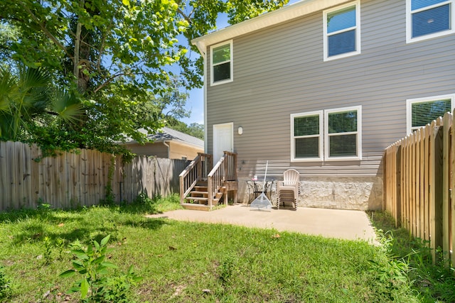 rear view of property featuring a patio and a lawn