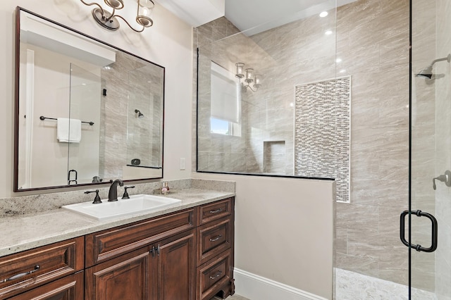 bathroom featuring a stall shower and vanity