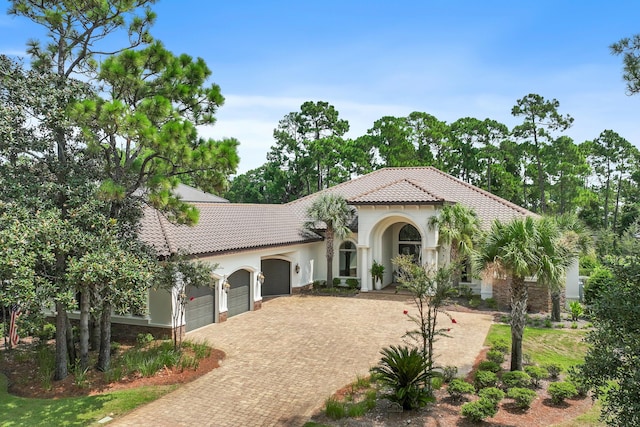 mediterranean / spanish-style home with a garage