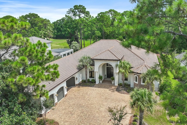 mediterranean / spanish-style home featuring a garage