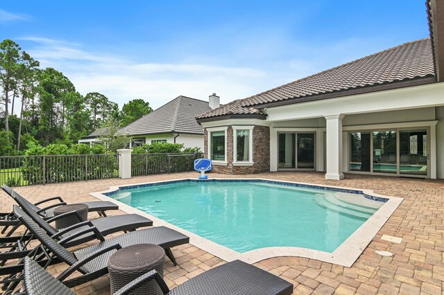 view of pool featuring fence, a fenced in pool, and a patio