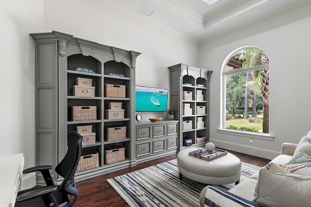 interior space featuring baseboards, a tray ceiling, dark wood-type flooring, and crown molding