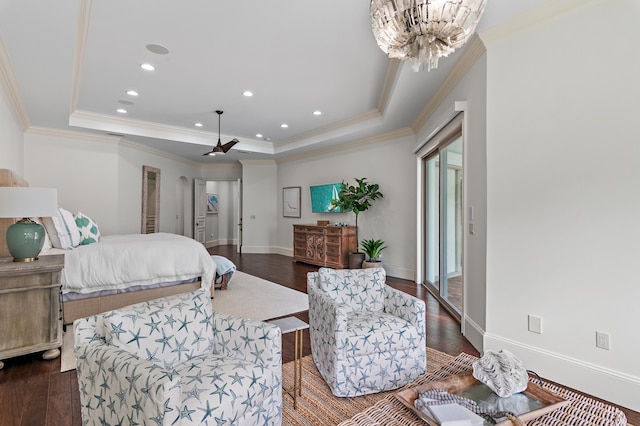 bedroom featuring crown molding, a tray ceiling, dark wood finished floors, and baseboards