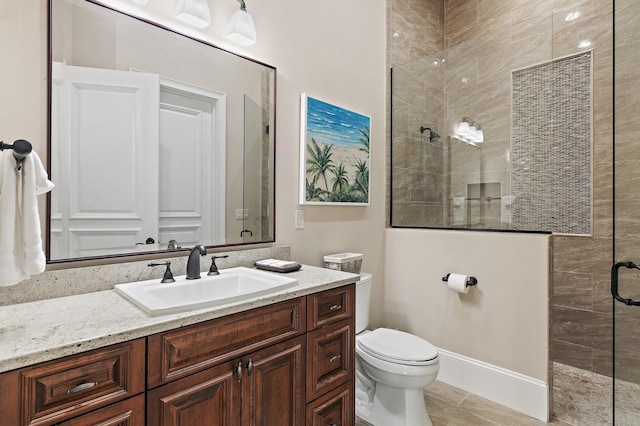 full bathroom with tiled shower, vanity, and toilet