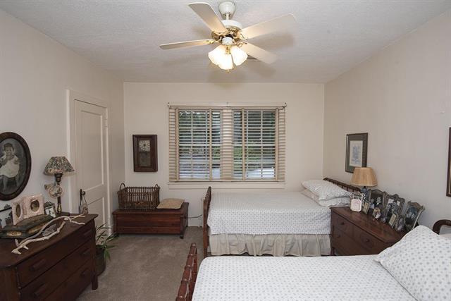 bedroom featuring light carpet and ceiling fan