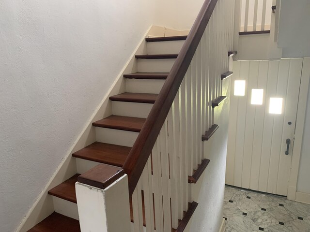 stairs with light tile patterned floors