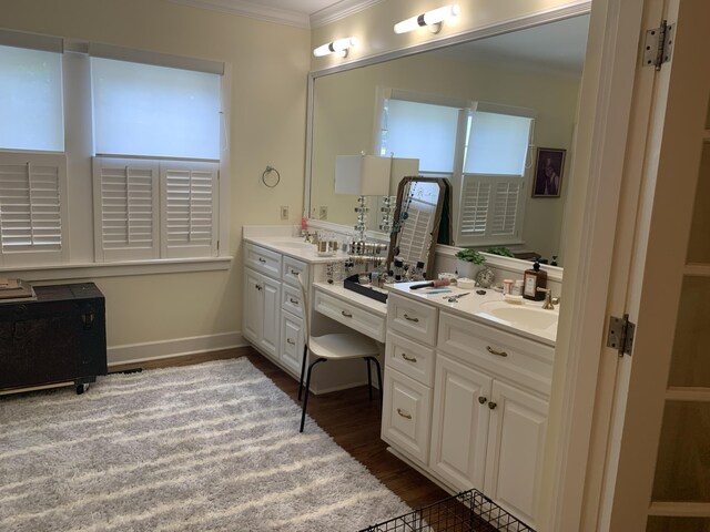 bathroom with vanity, crown molding, and wood-type flooring