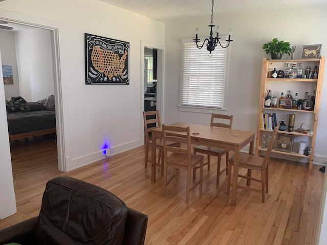 dining room featuring a notable chandelier and light hardwood / wood-style floors