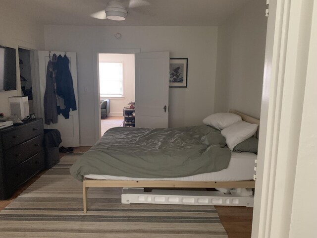 bedroom featuring wood-type flooring and ceiling fan