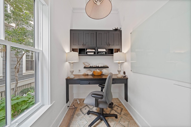 office area with light hardwood / wood-style flooring and built in desk